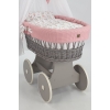 culla di vimini grigia con drappeggio rosa chiaro